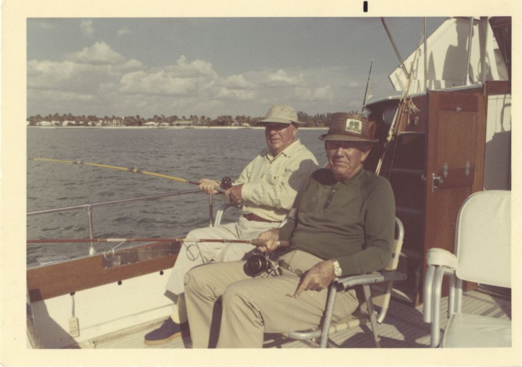 Richard J. Daley and a man fishing from a boat