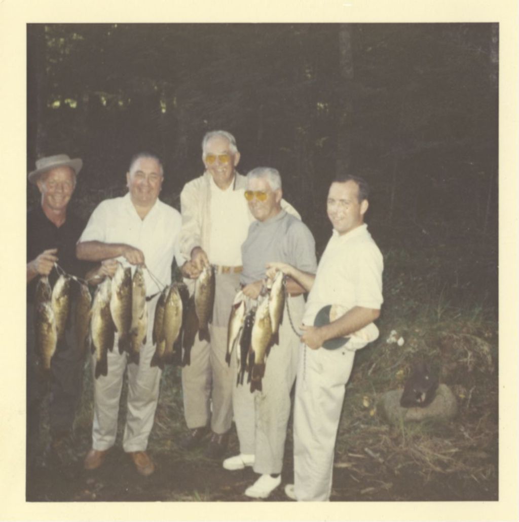 Richard J. Daley and others display their catch of fish