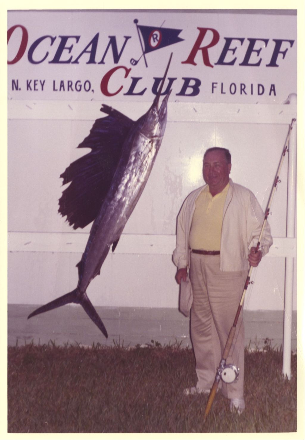 Richard J. Daley standing next to a mounted swordfish in Key Largo, Florida