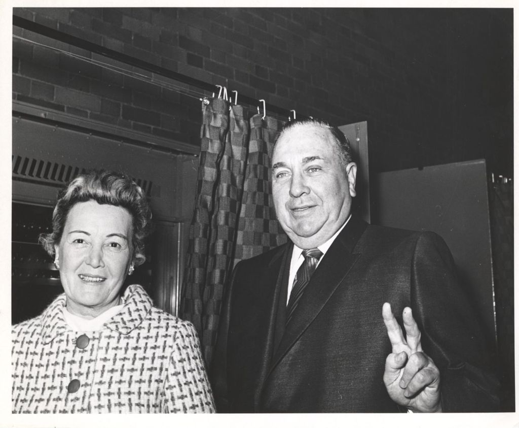 Eleanor and Richard J. Daley beside a voting booth