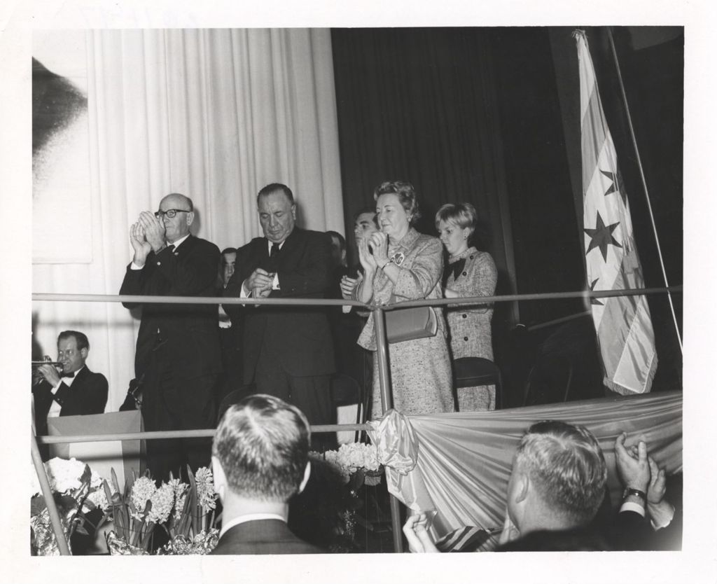 Miniature of Richard J. Daley on a stage with Fire Commissioner Quinn, and family members