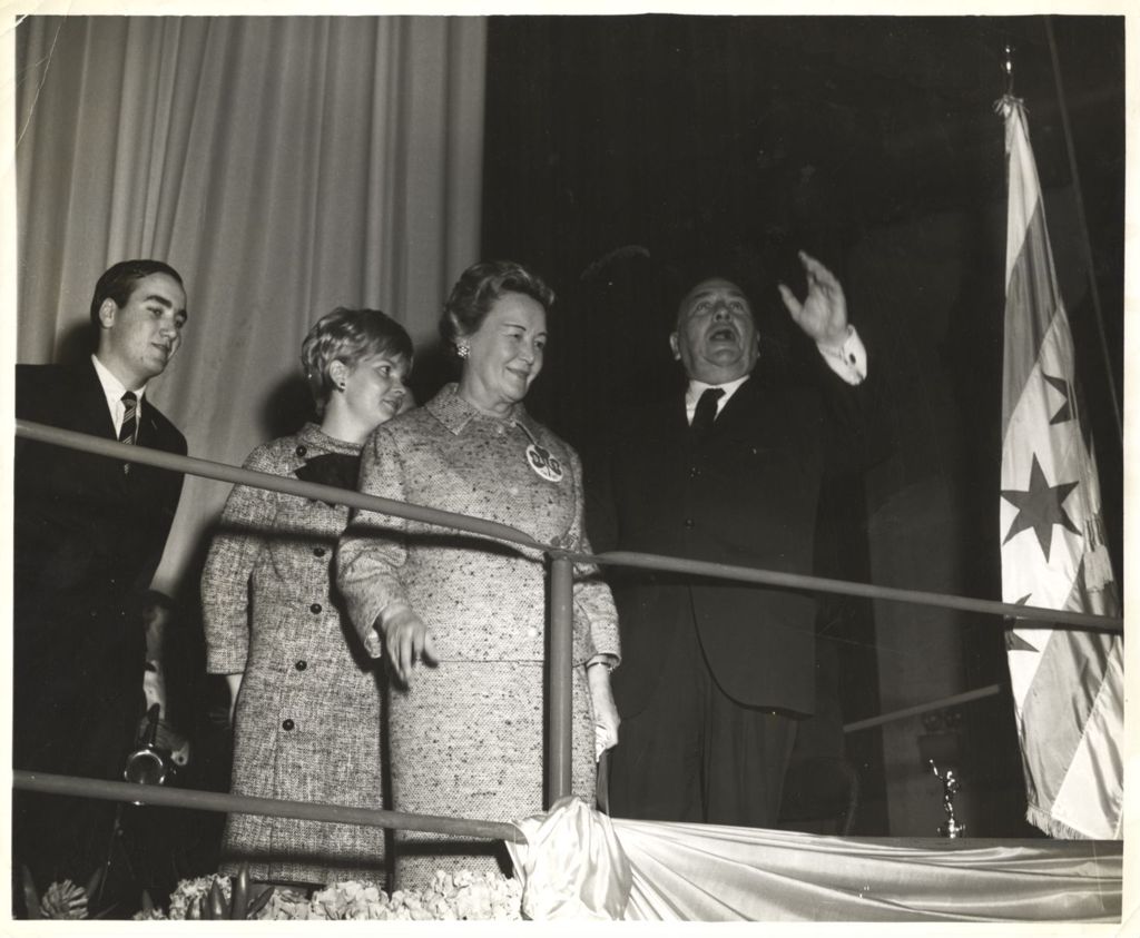 Miniature of Richard J. Daley speaking on a stage with family members beside him