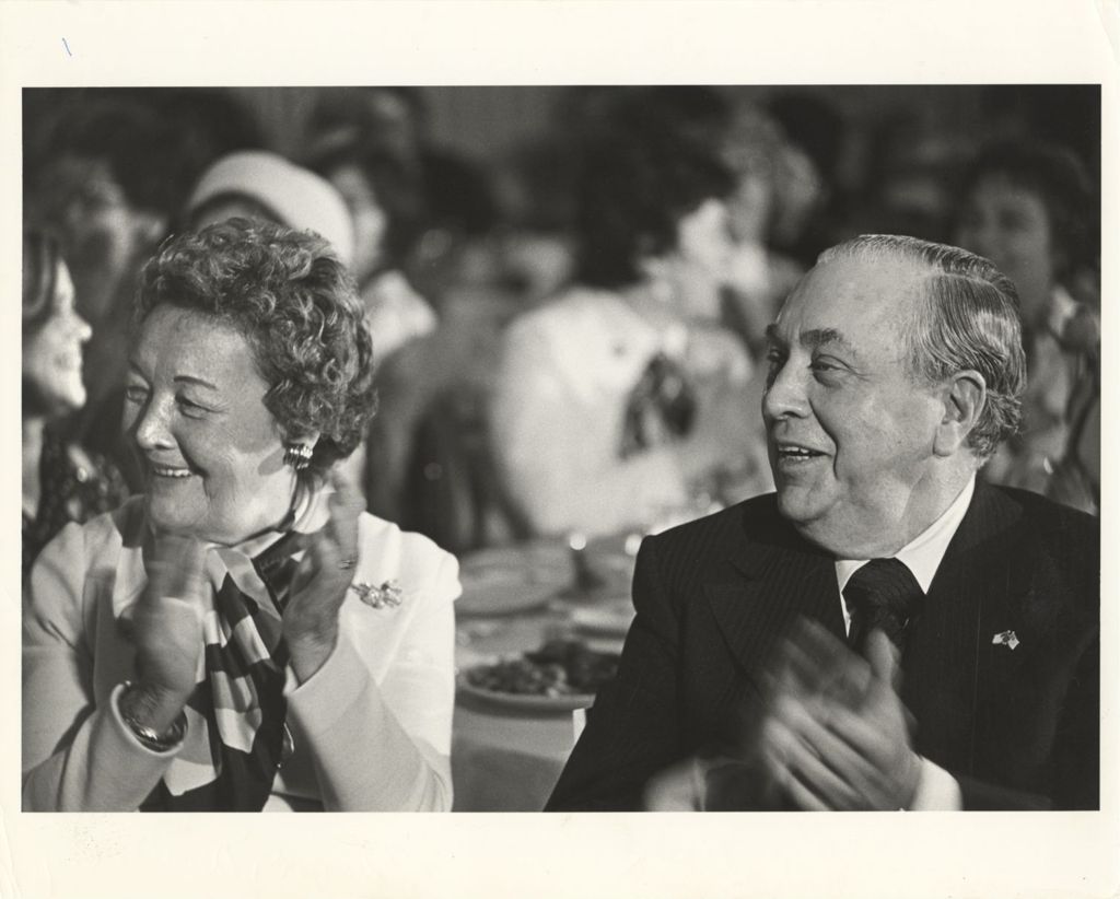 Miniature of Eleanor and Richard J. Daley applauding at a banquet