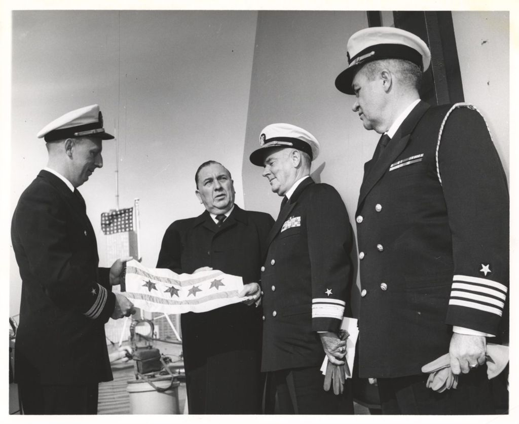 Miniature of Richard J. Daley presents a Chicago flag to Naval officers