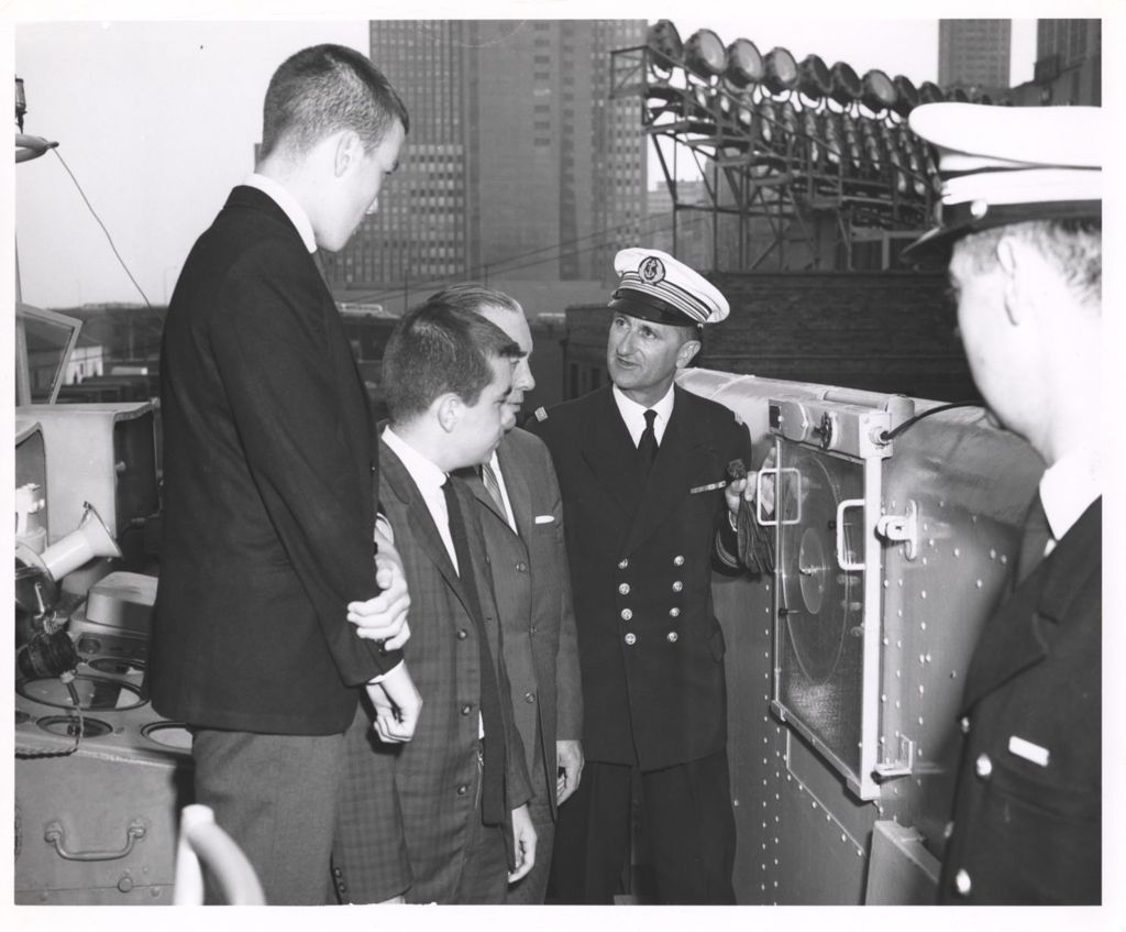 Miniature of Naval officer showing ship's equipment to Richard J. Daley, William Daley, and John Daley