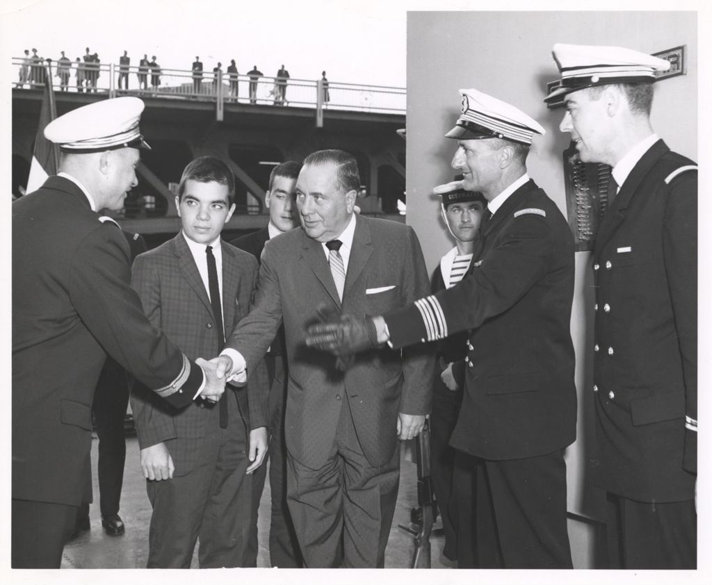 Richard J. Daley on a ship, shaking hands with a Naval officer