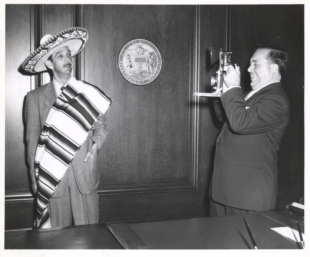 Richard J. Daley photographing a man in a sombrero