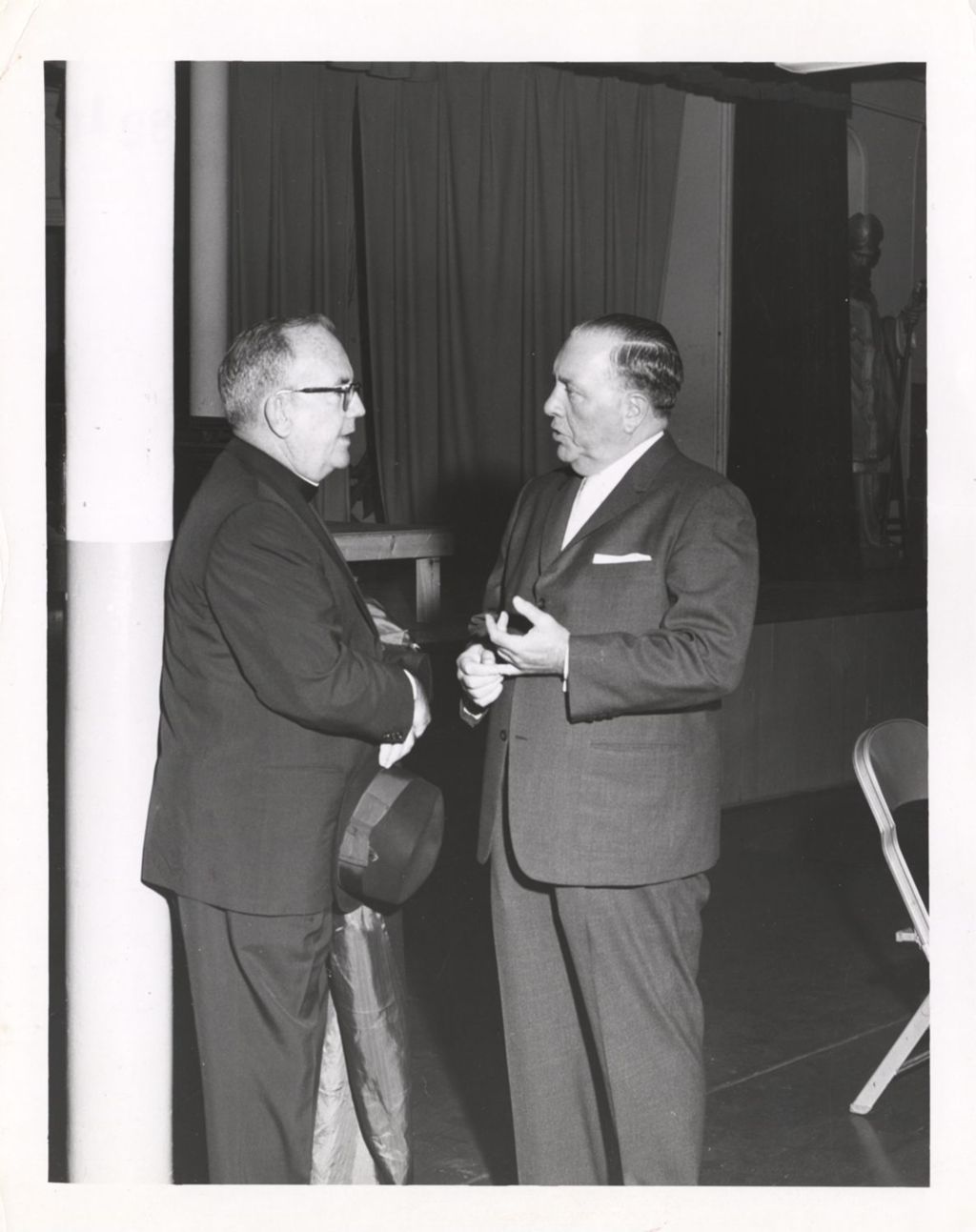Miniature of Richard J. Daley speaking with a priest