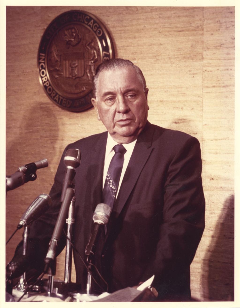 Richard J. Daley at a podium with a bank of microphones