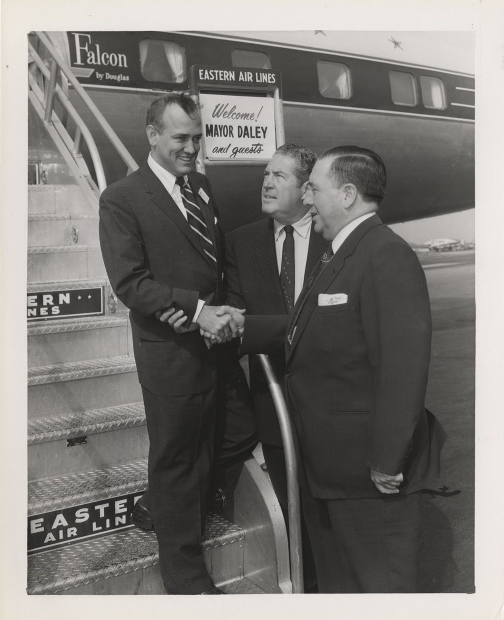 Miniature of Richard J. Daley greeting a man stepping off a plane