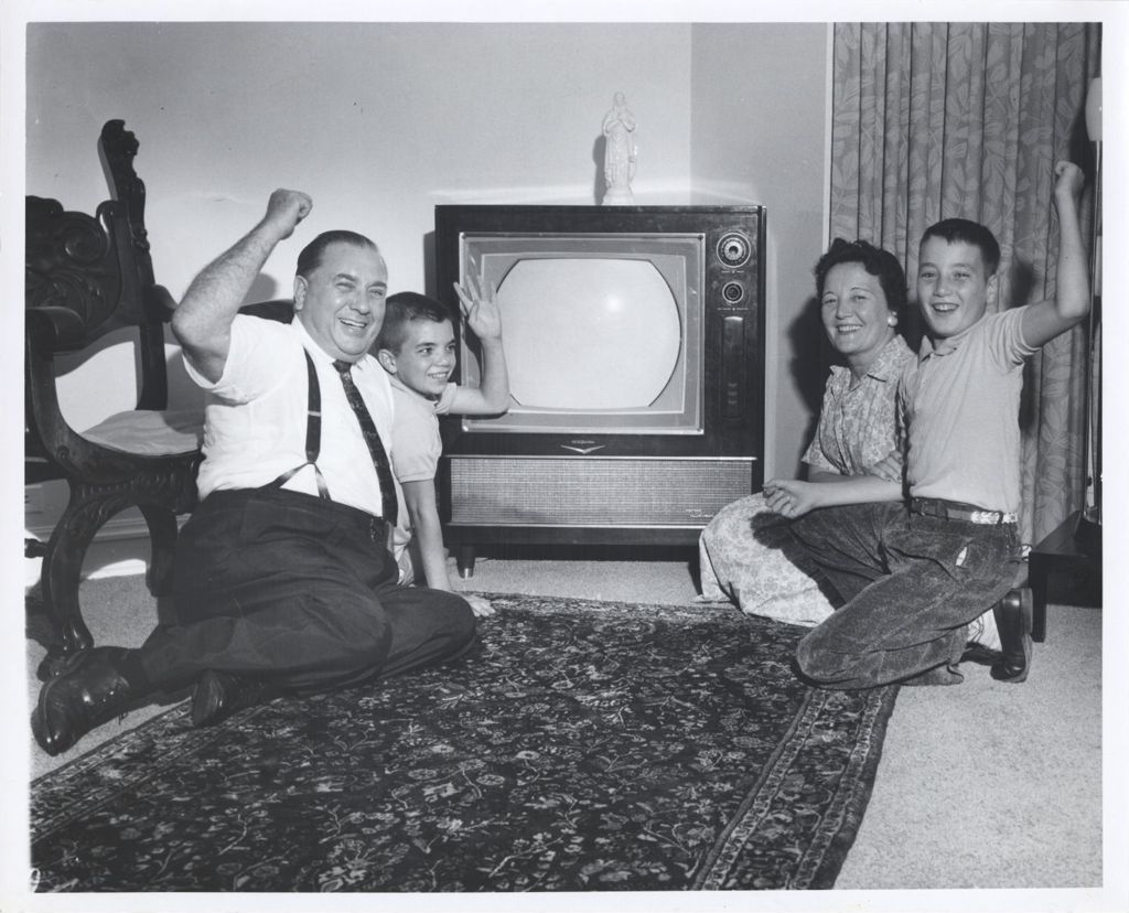 Daley family cheers in front of television