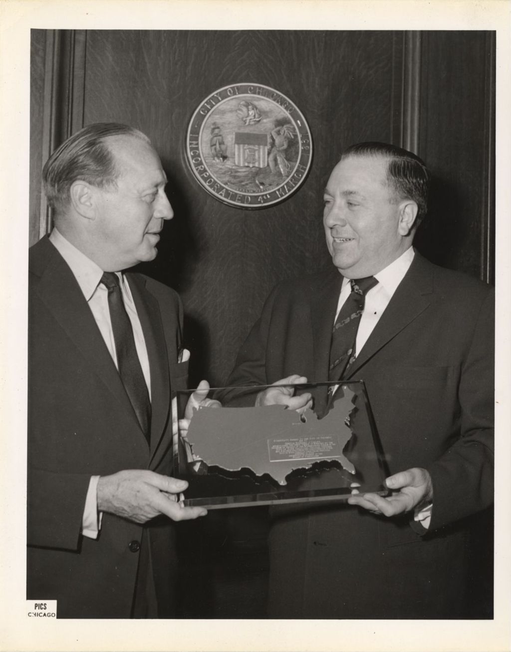Richard J. Daley accepts an award plaque