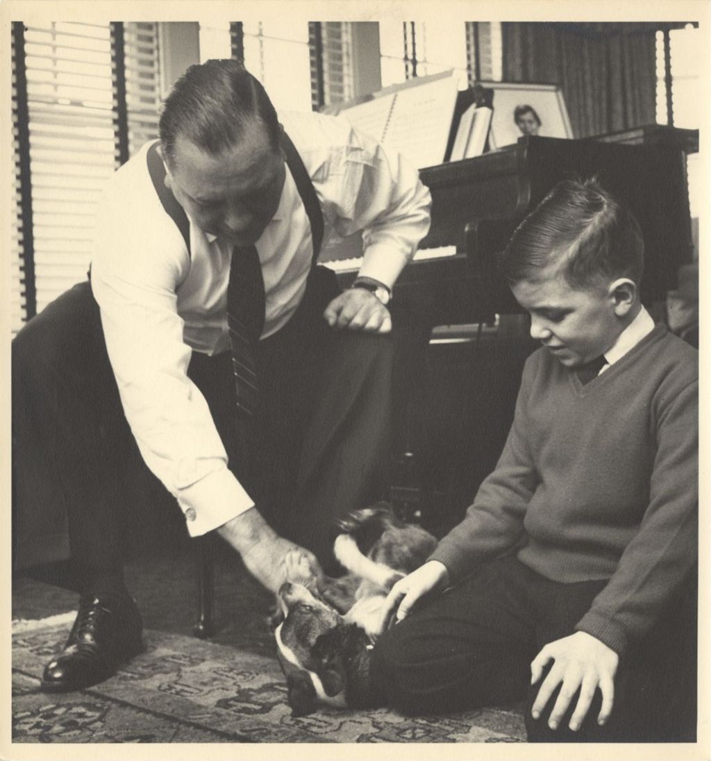 Miniature of Richard J. and John Daley playing with their dog