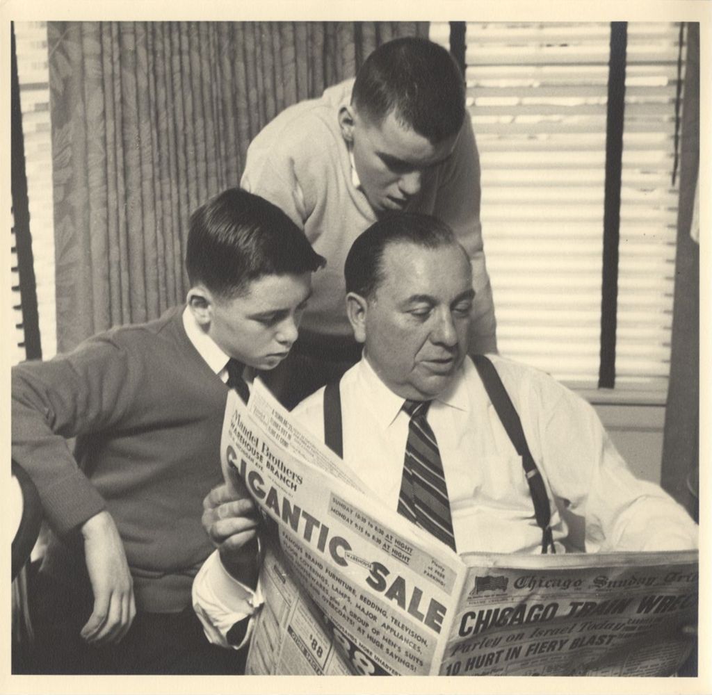 Miniature of Daley family reading the newspaper