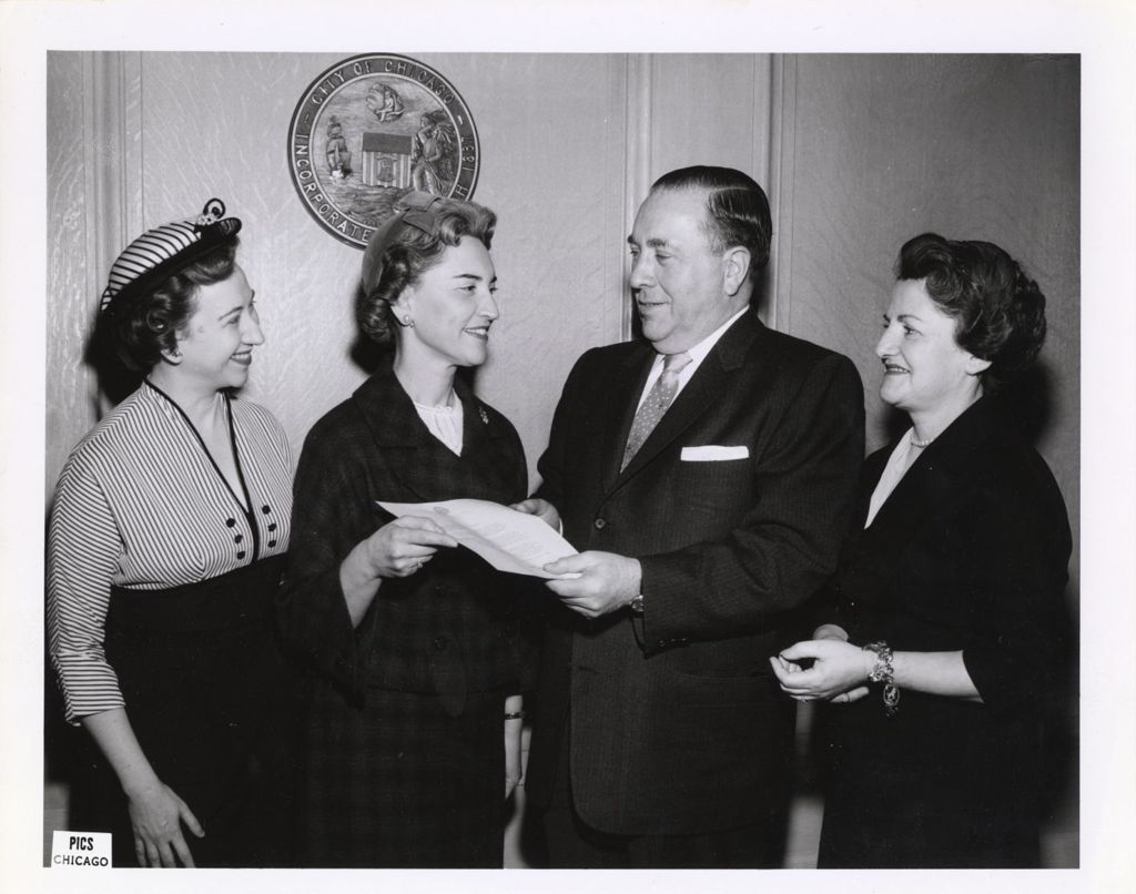 Miniature of Richard J. Daley and group of women with a document