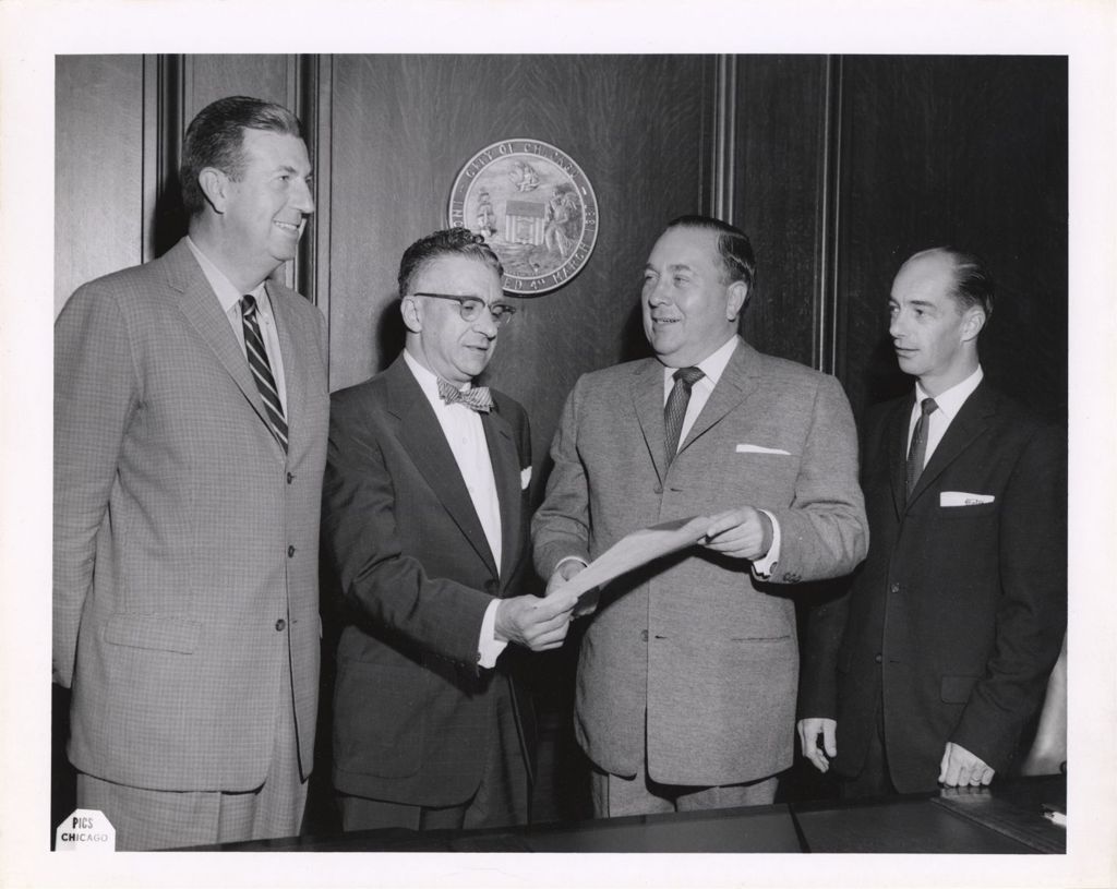 Miniature of Richard J. Daley and group with a document