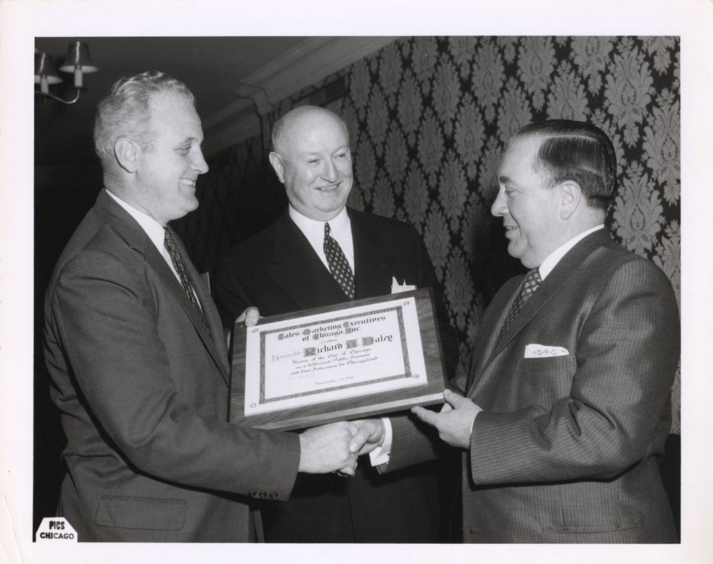 Miniature of Richard J. Daley accepting plaque from Sales Marketing Executives of Chicago