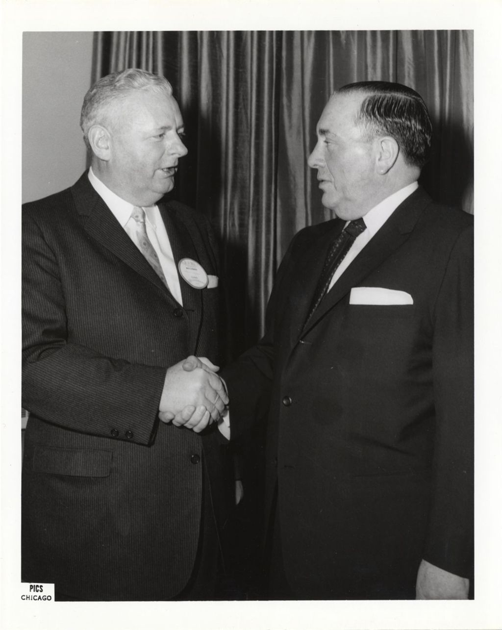 Richard J. Daley shaking hands with a man