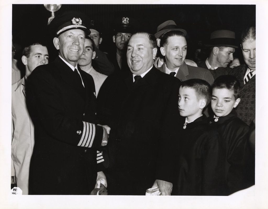 Miniature of Richard J.Daley shakes hands with a man in uniform