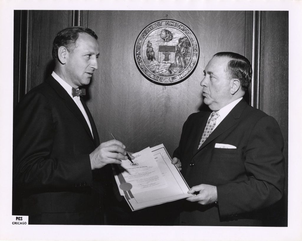 Miniature of Richard J. Daley and man with a document