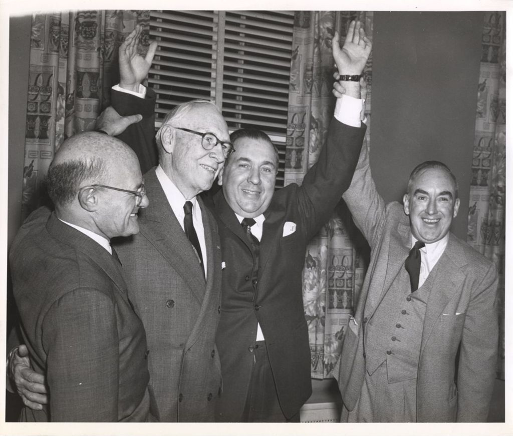 Richard J. Daley with arms raised in victory