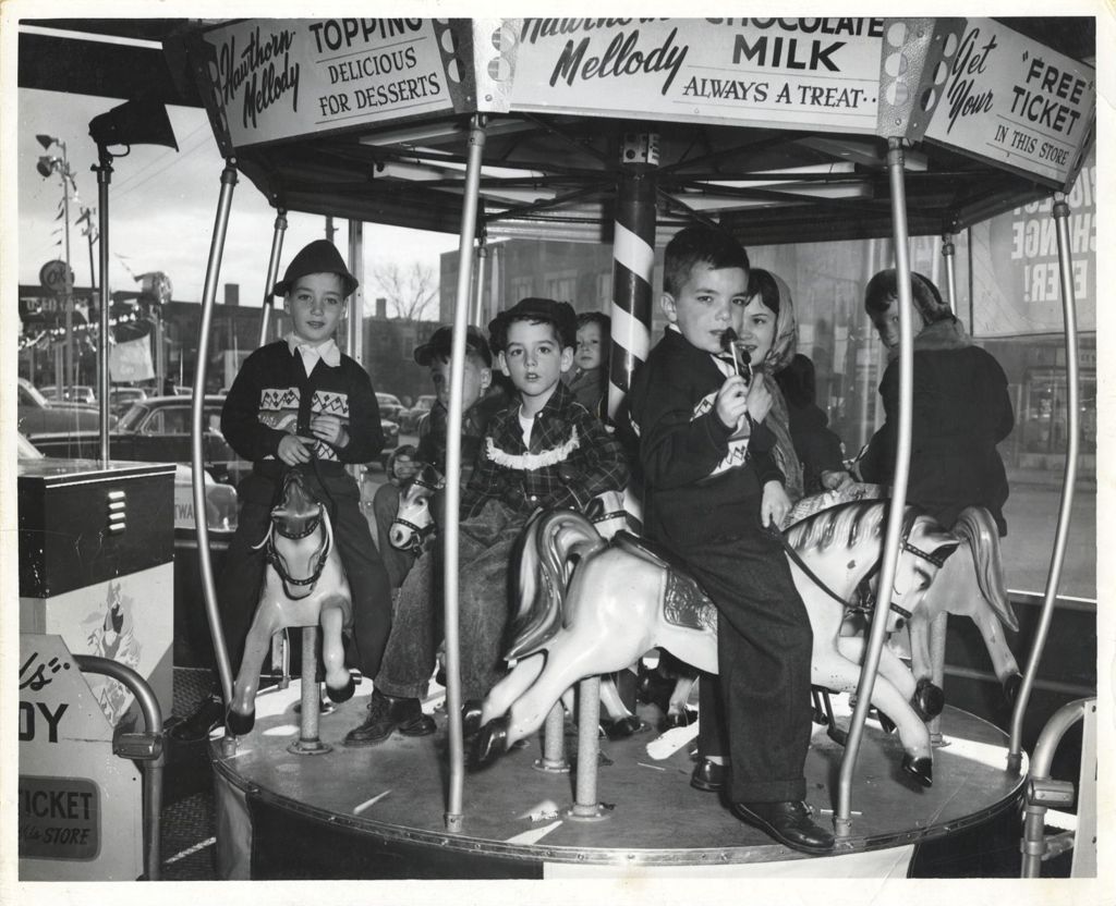 Miniature of William Daley and John Daley riding a carousel