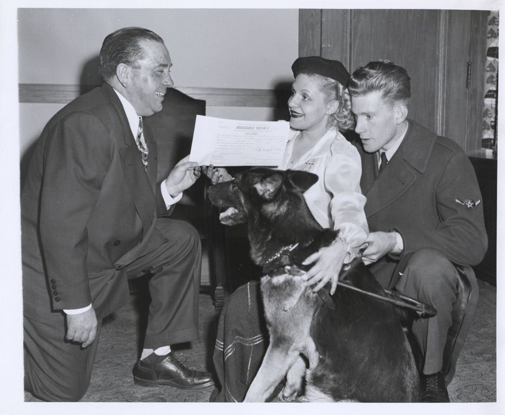 Miniature of Richard J. Daley issuing a marriage license to a couple with a guide dog