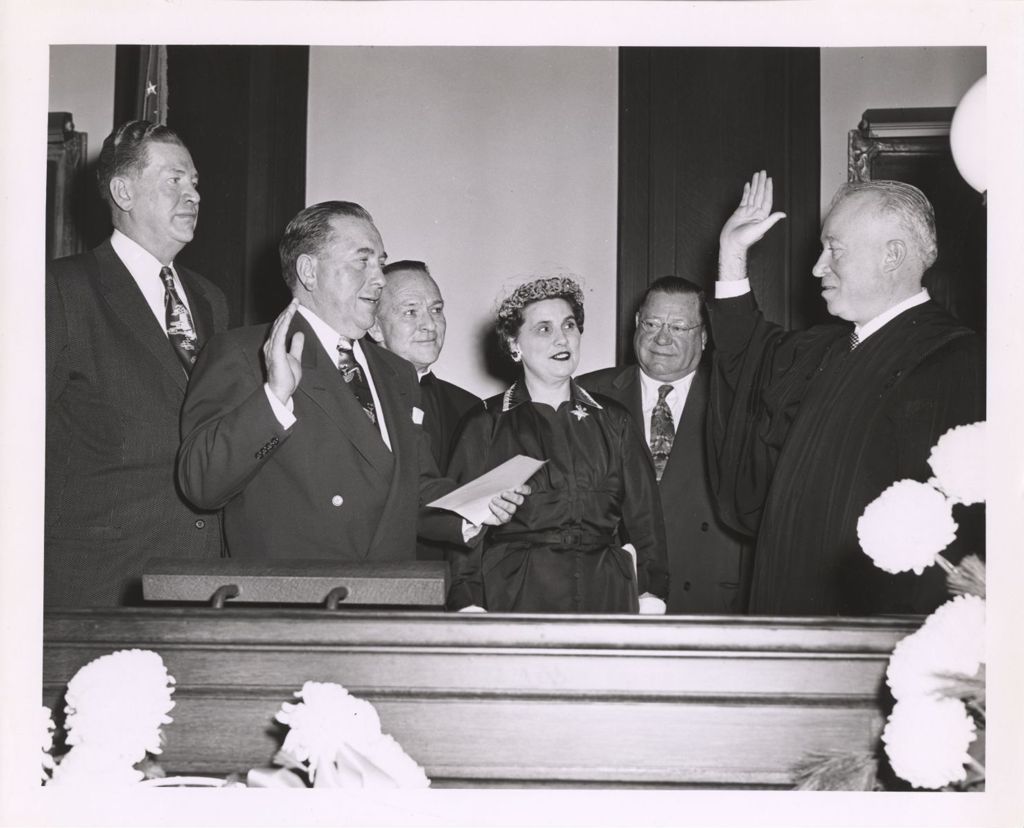 Richard J. Daley administers oath to a judge