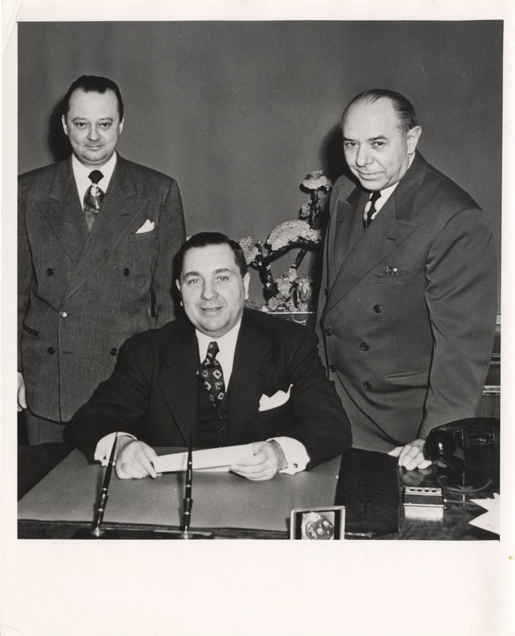 Miniature of Richard J. Daley at his desk with two men