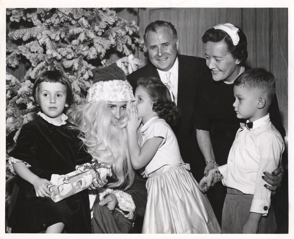 Miniature of Eleanor Daley with children visiting Santa at Toys for Tots event