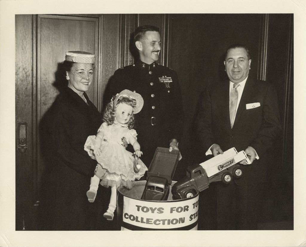 Eleanor Daley and Richard J. Daley displaying toys