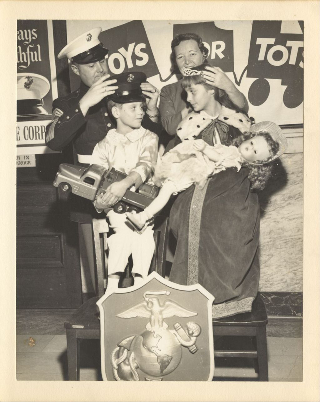 Miniature of Eleanor Daley presenting toys to children