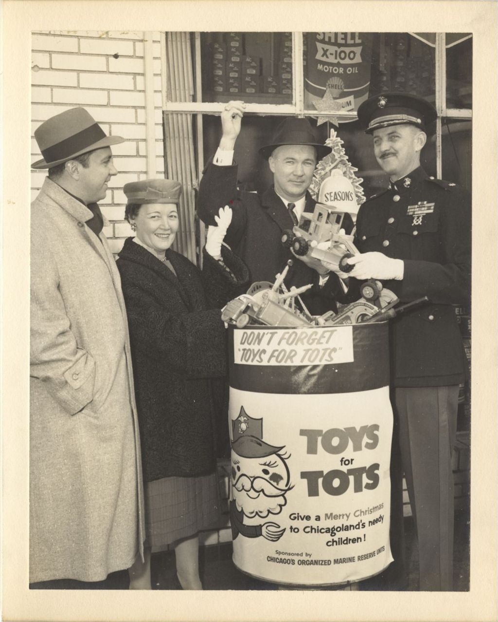 Miniature of Eleanor Daley with the Toys for Tots collection bin