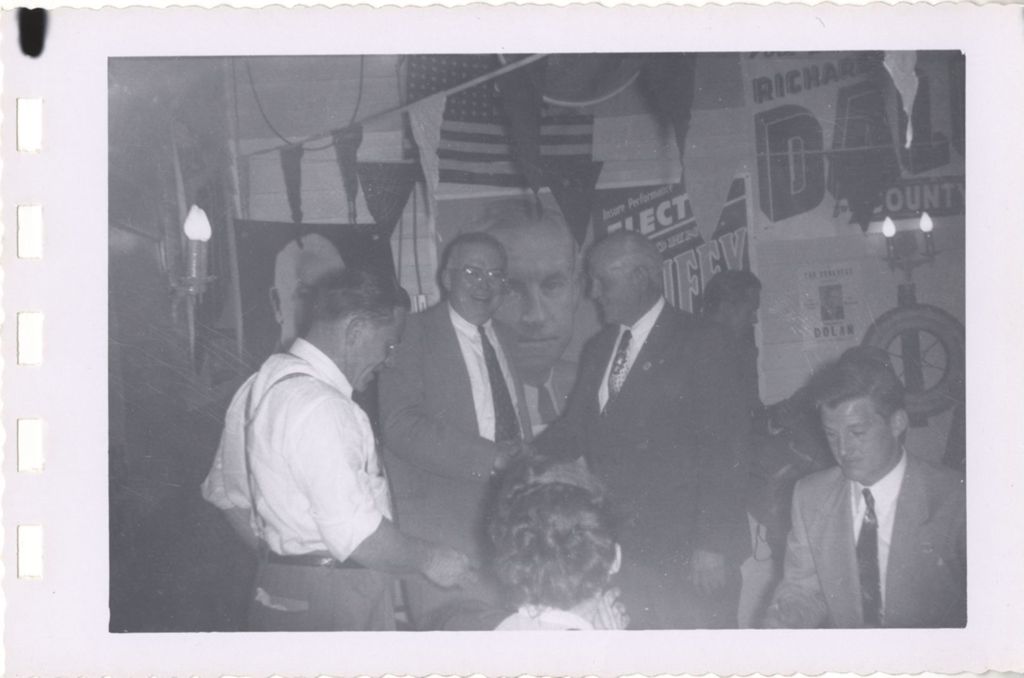 Miniature of Men shaking hands at a campaign event