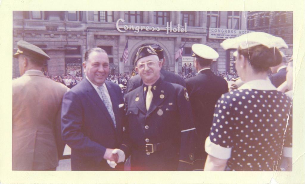 Richard J. Daley shaking hands with a uniformed veteran