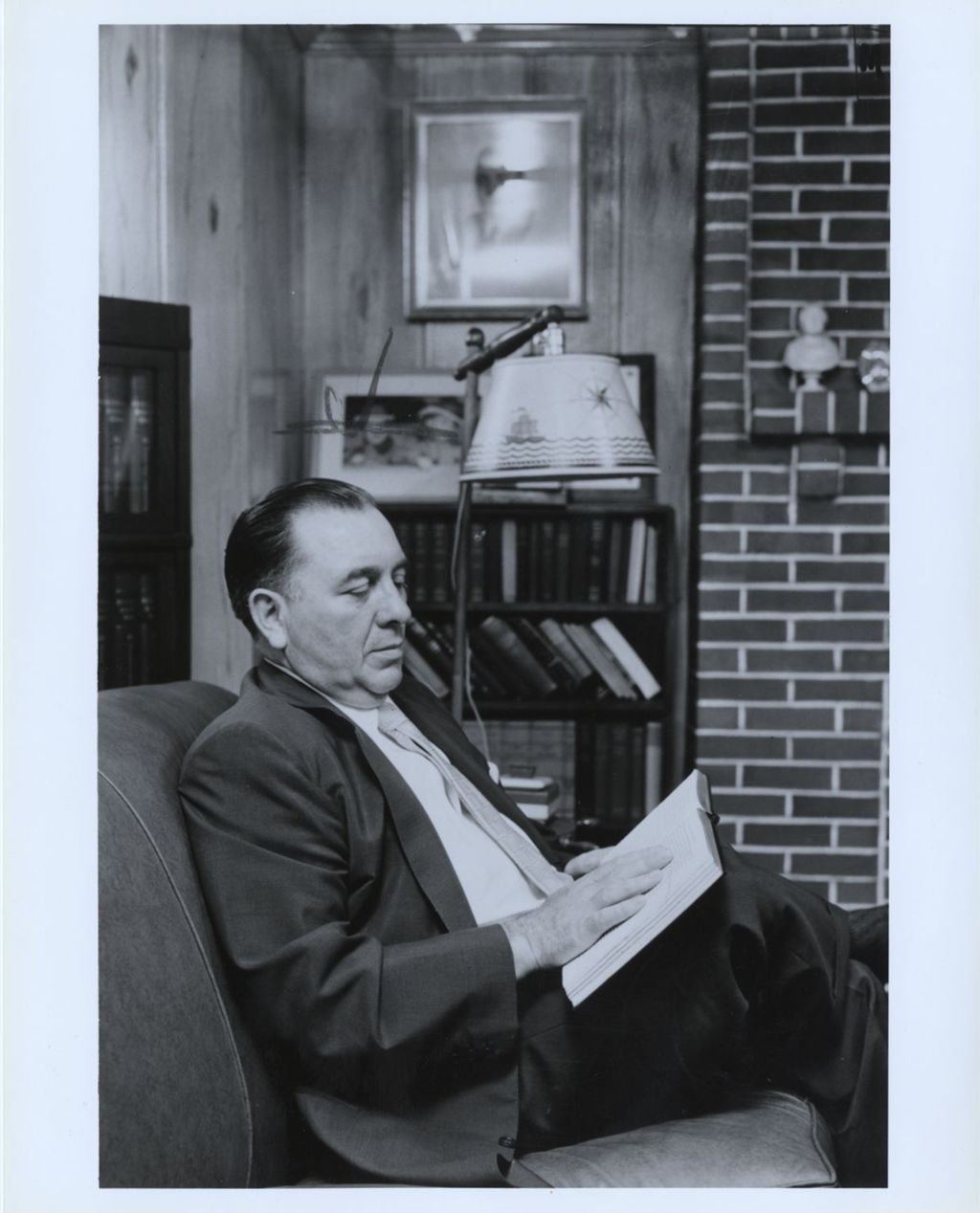 Miniature of Richard J. Daley reading at home