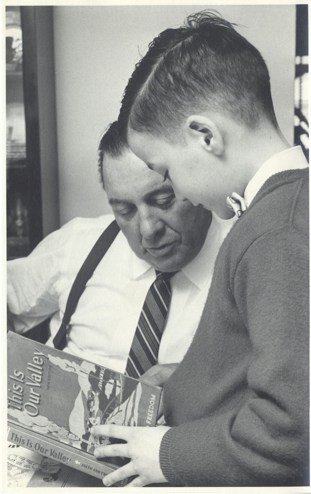 Miniature of Richard J. Daley and his son with a school book
