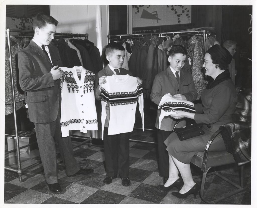Miniature of Michael, John, and William Daley showing sweaters to their mother