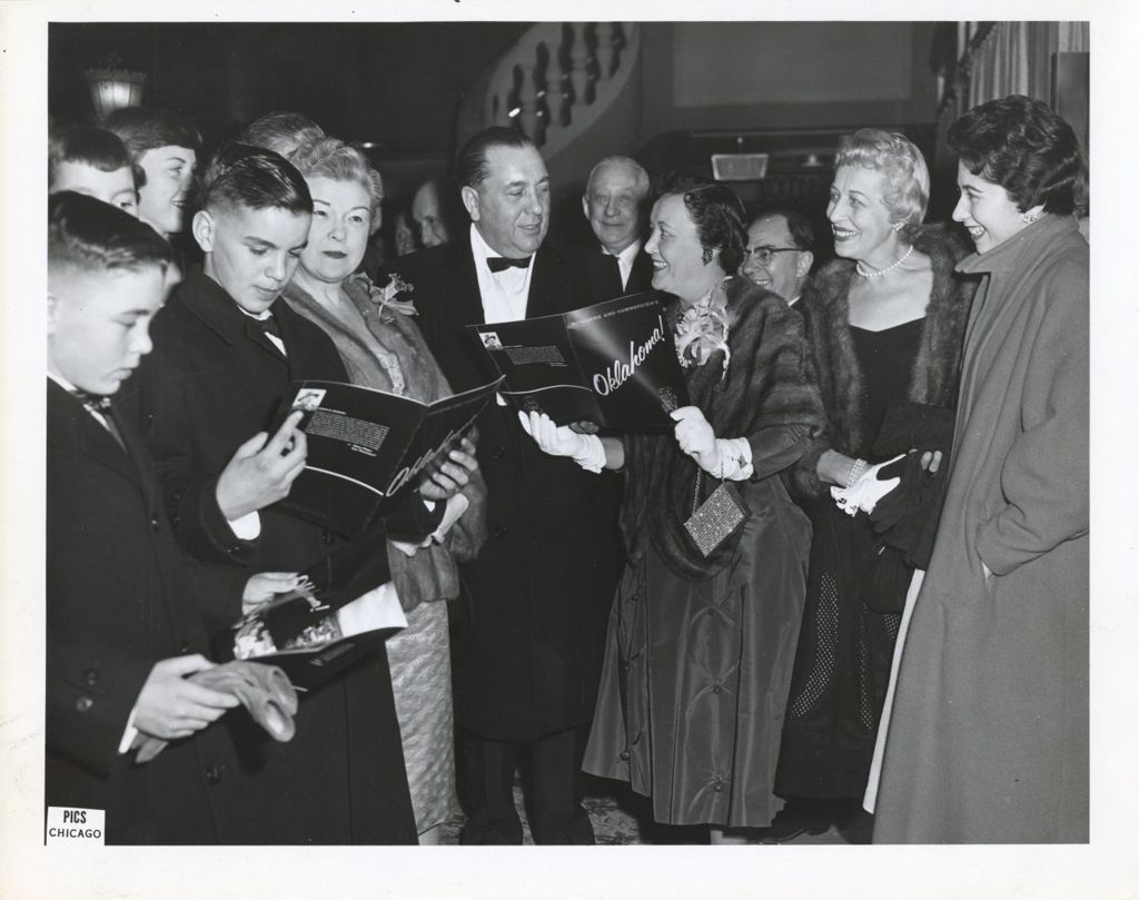 Miniature of Richard J. Daley, with family members and others in the lobby of a theater