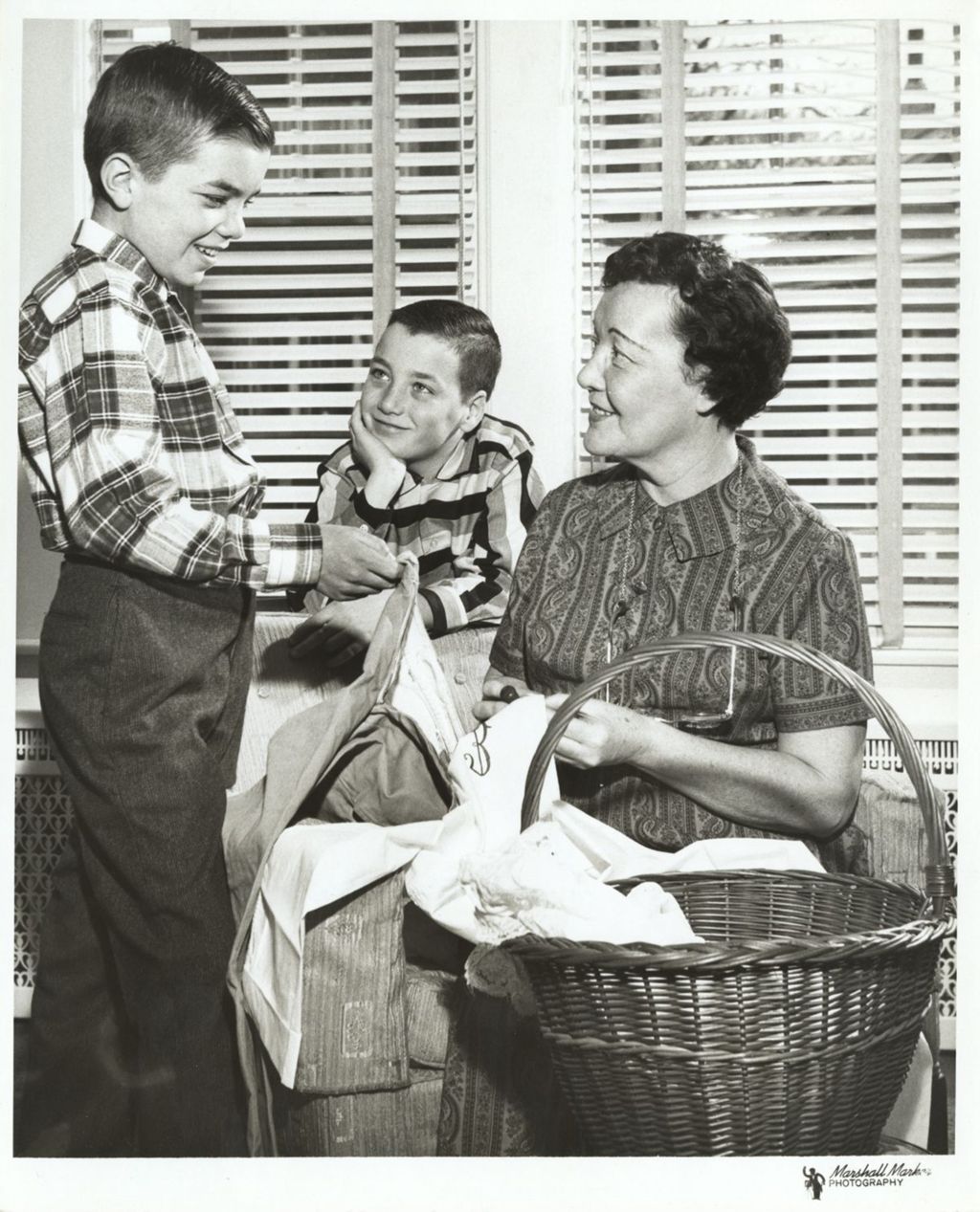 Miniature of Eleanor Daley folding laundry with her sons