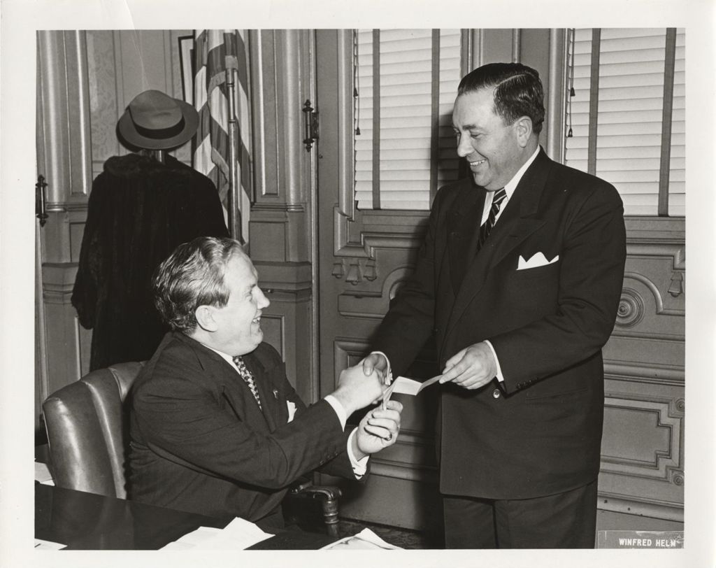 Edward J. Barrett and Richard J. Daley shaking hands