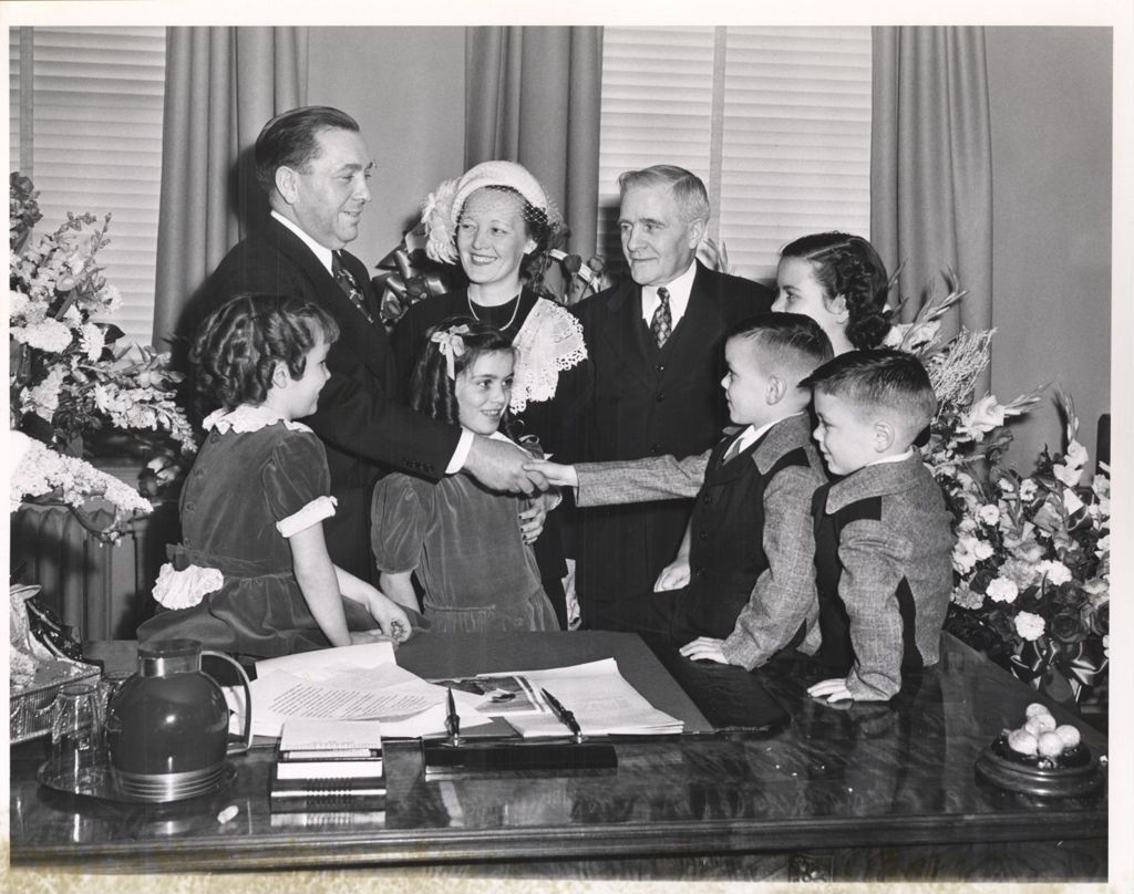 Miniature of Richard J. Daley with his family at his installation as Director of the Department of Revenue