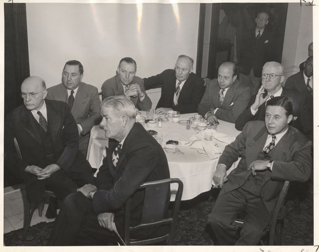 Richard J. Daley seated at a table with others