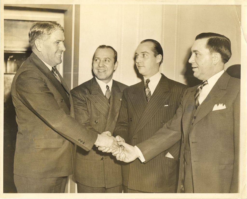 Richard J. Daley in a group handshake with others