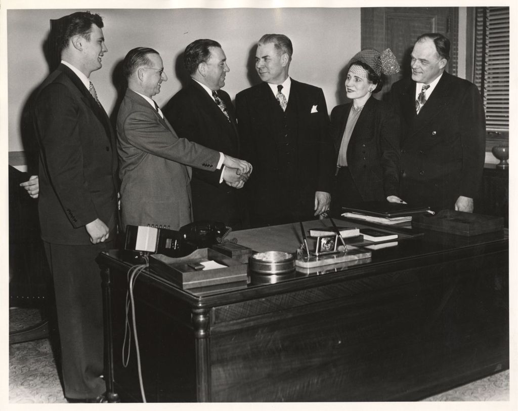 Richard J. Daley participating in a group handshake