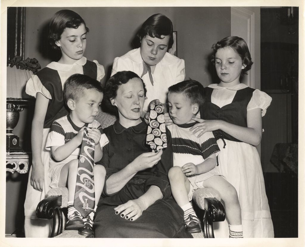 Miniature of Eleanor Daley looking at neckties with her children