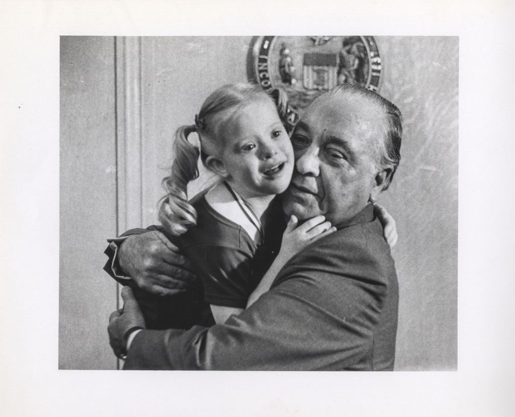 Miniature of Richard J. Daley holding a young Special Olympics participant
