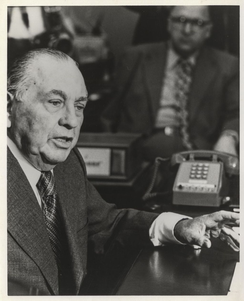 Miniature of Richard J. Daley speaking at his desk