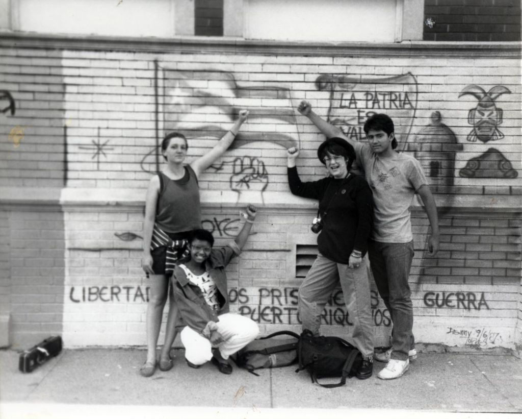 Miniature of Young people in front of political mural