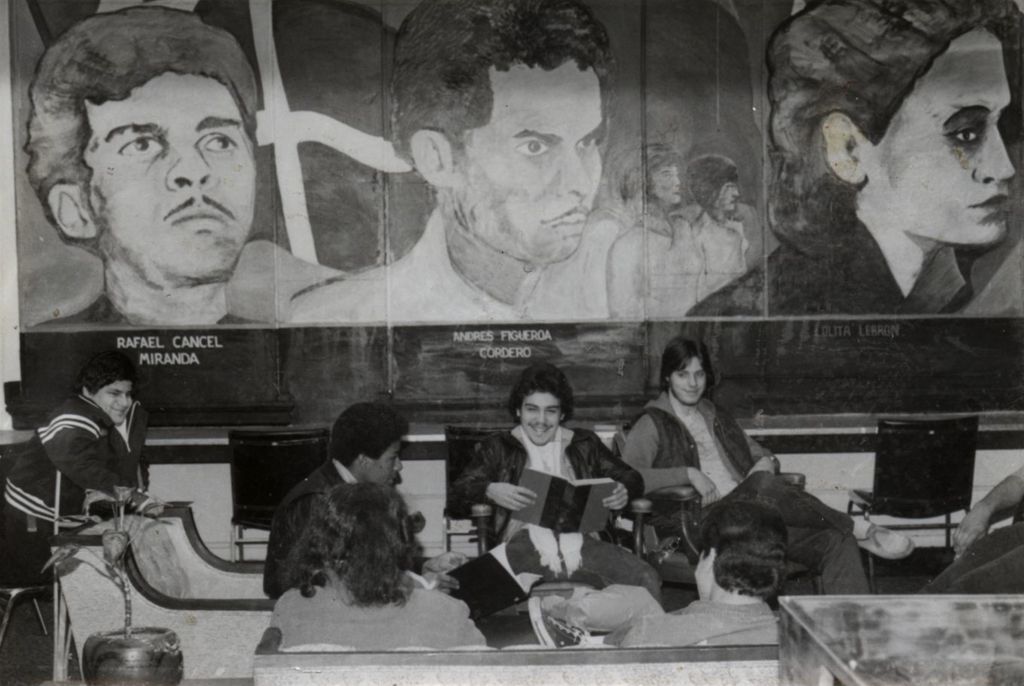 Miniature of Young people sitting beneath murals of Puerto Rican political figures
